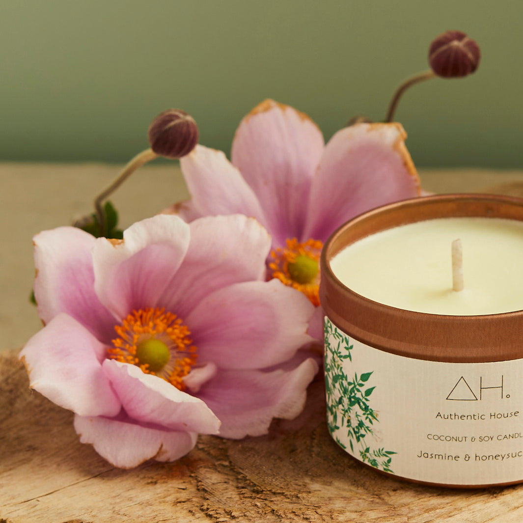 Jasmine Coconut and Soy Candle Next to Pink Anemone Flowers