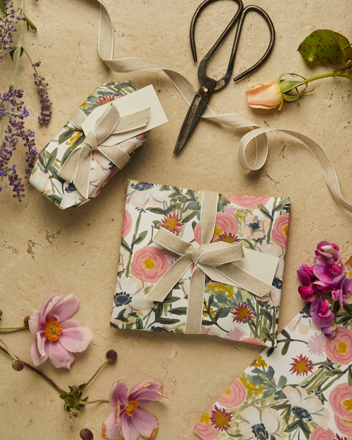Gifts wrapped in floral paper with linen ribbon