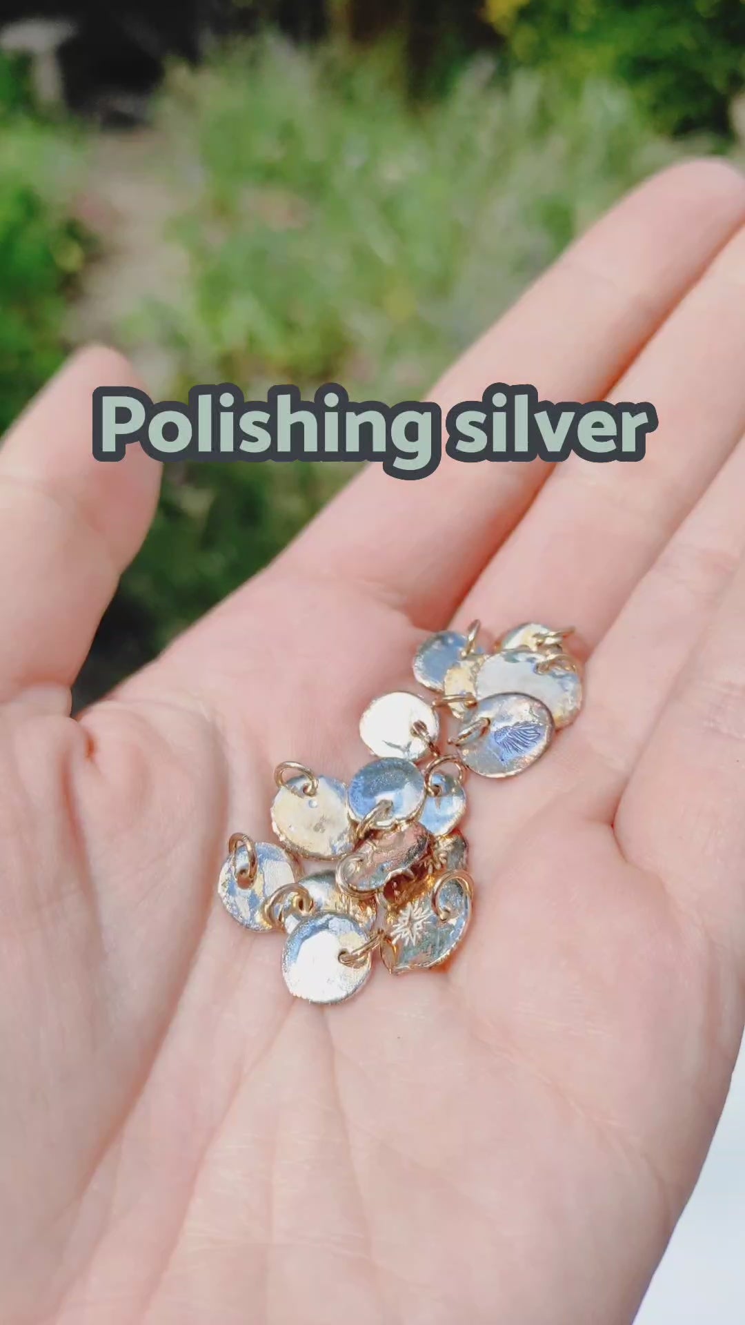 Polishing recycled silver charm necklaces